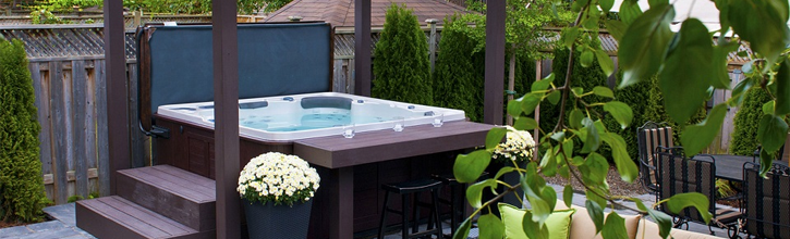 A hot tub setup in an area with blooming greens