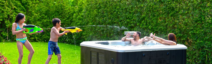 Family having fun in the sun in hot tub